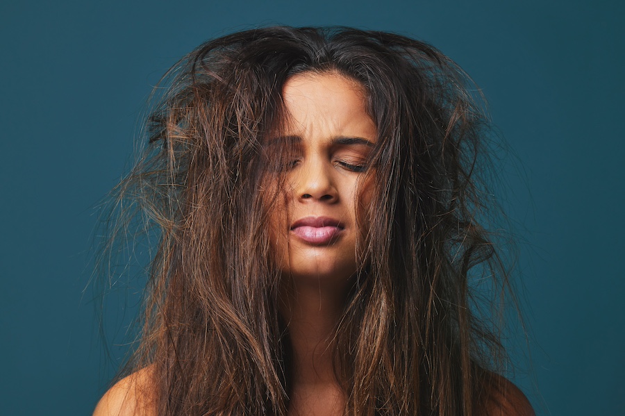 young woman with messy frizzy hair